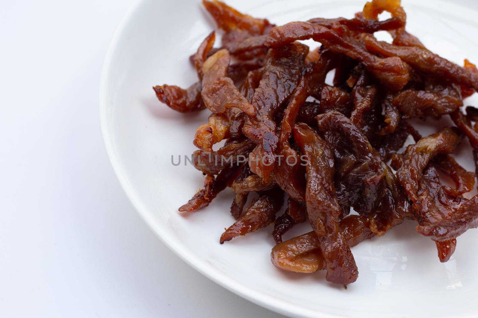 Deep fried sun-dried pork on white background. Top view