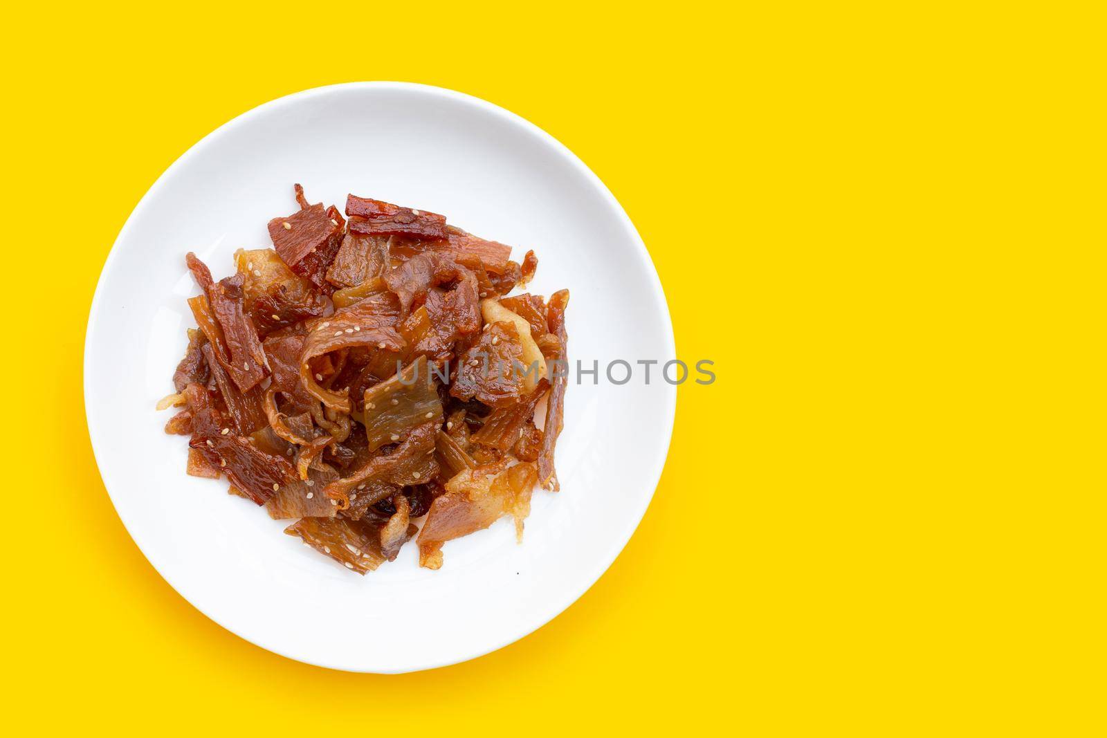 Sweet pork or pork Jerky on yellow background. Top view