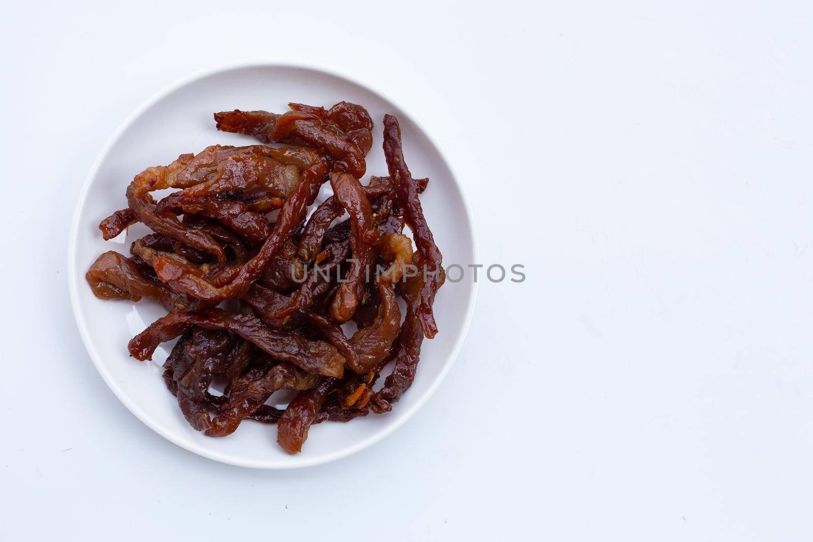 Deep fried sun-dried pork on white background. Top view