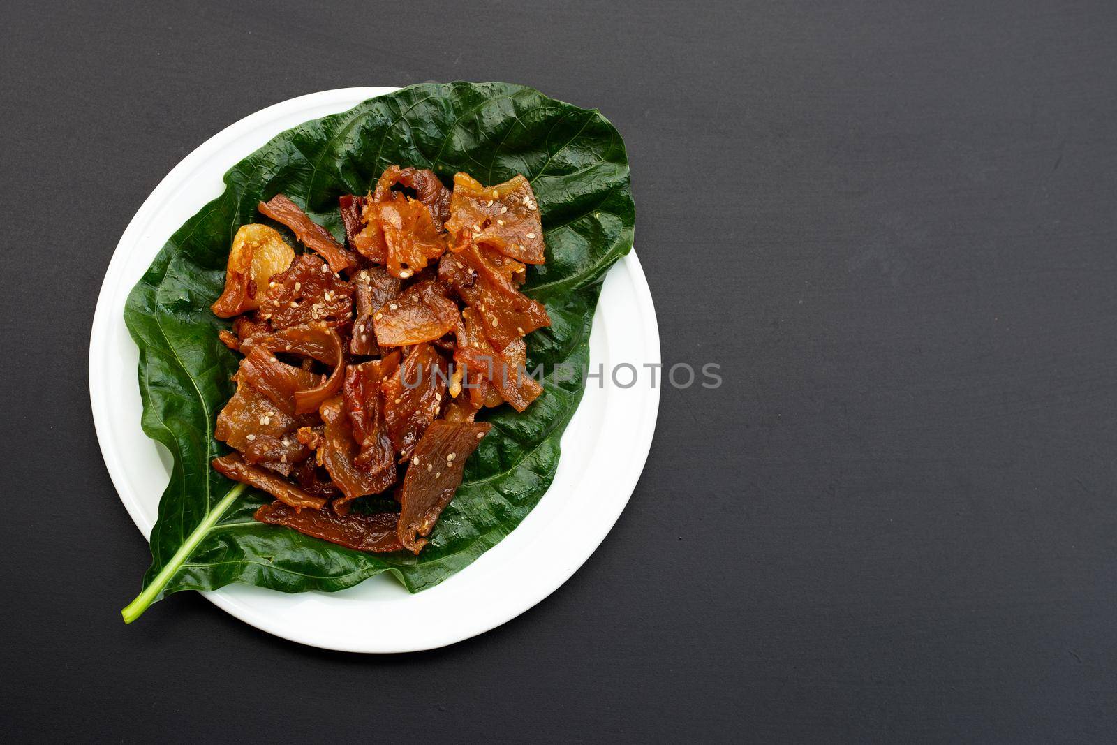 Sweet pork or pork Jerky on dark background. Top view