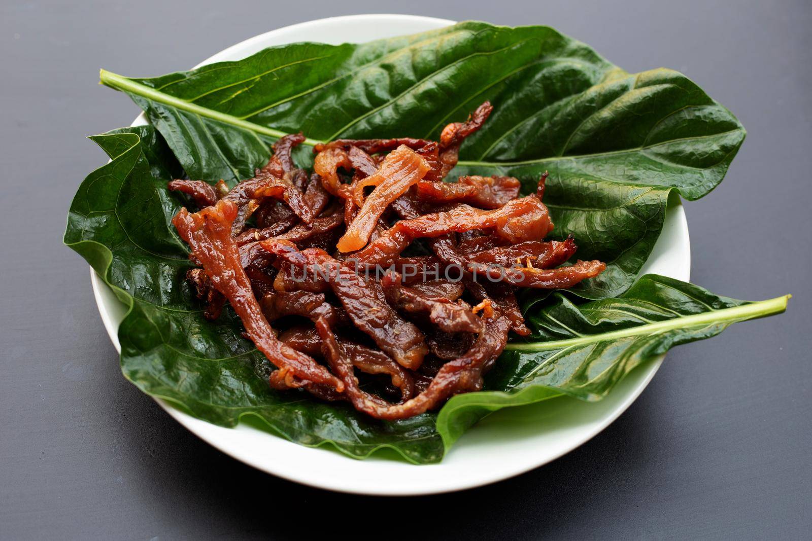 Deep fried sun-dried pork on dark background