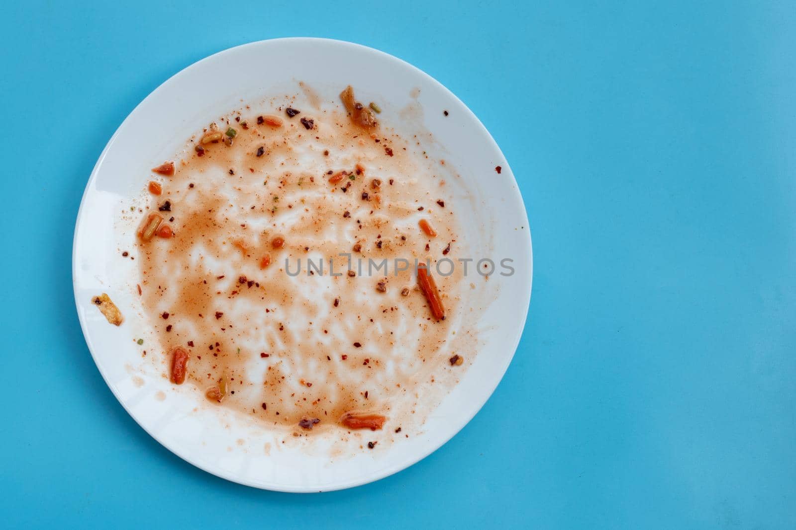 Dirty dish on blue background. Top view