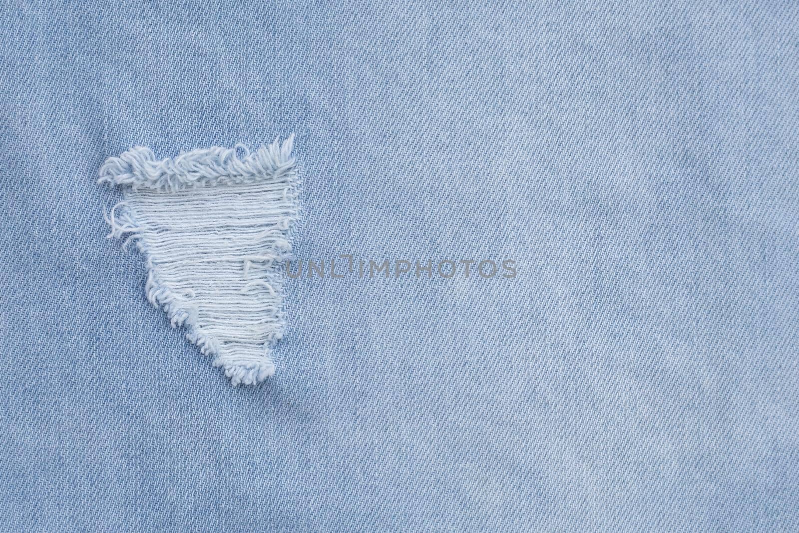 Close up of hole on jeans texture for background.