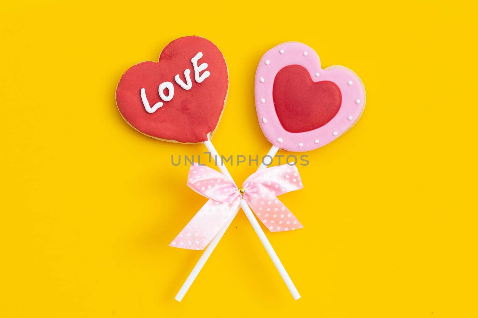 Valentineheart shapped cookies on yellow background.  Copy space