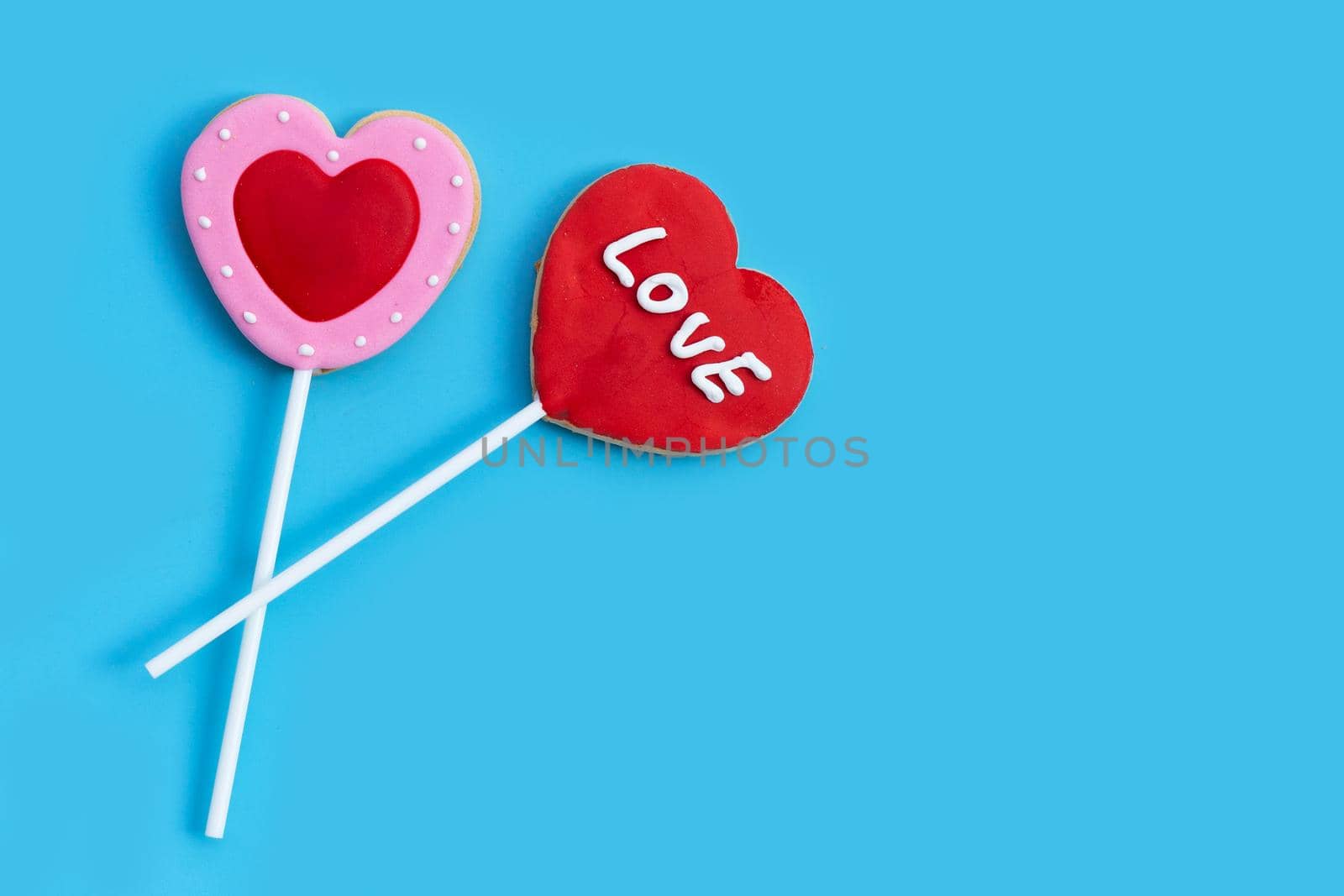 Valentineheart shapped cookies on blue background.  Copy space