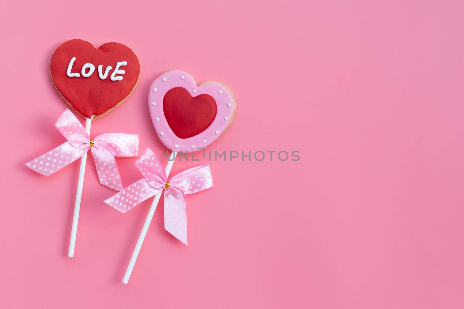 Valentineheart shapped cookies on pink background.  Copy space