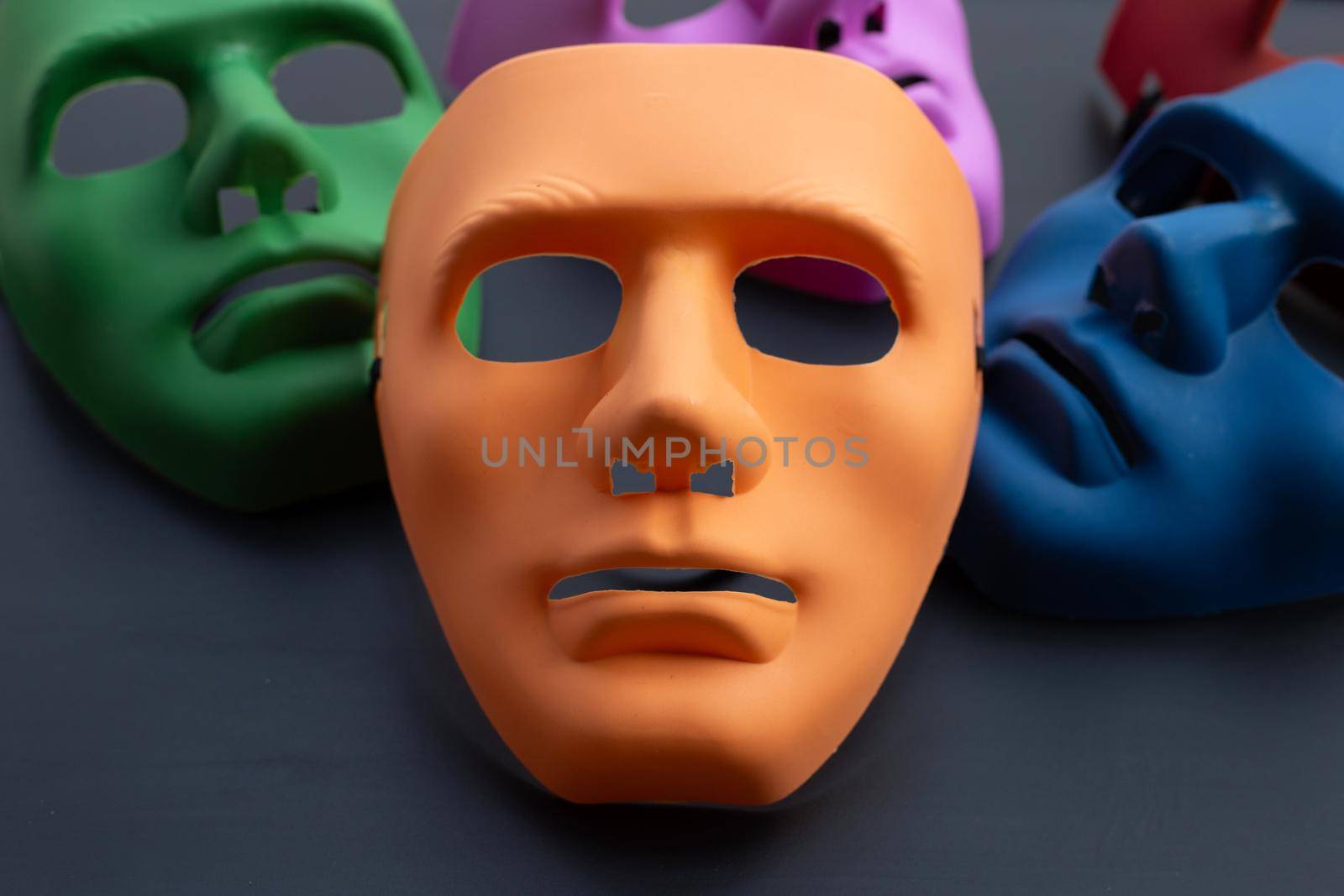 Five face masks on dark background.