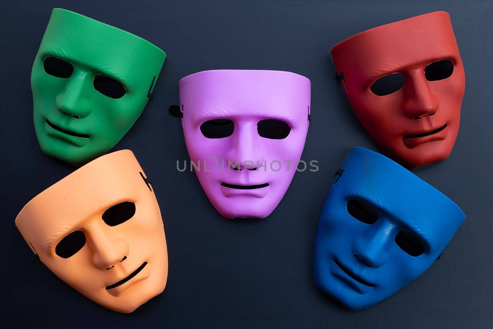 Five face masks on dark background. Top view