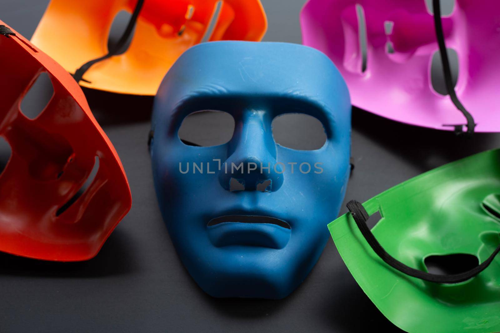 Five face masks on dark background.