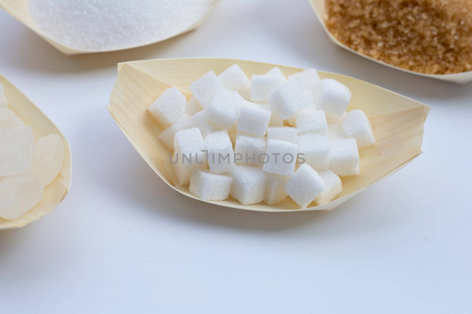 Various types of sugar on white background.