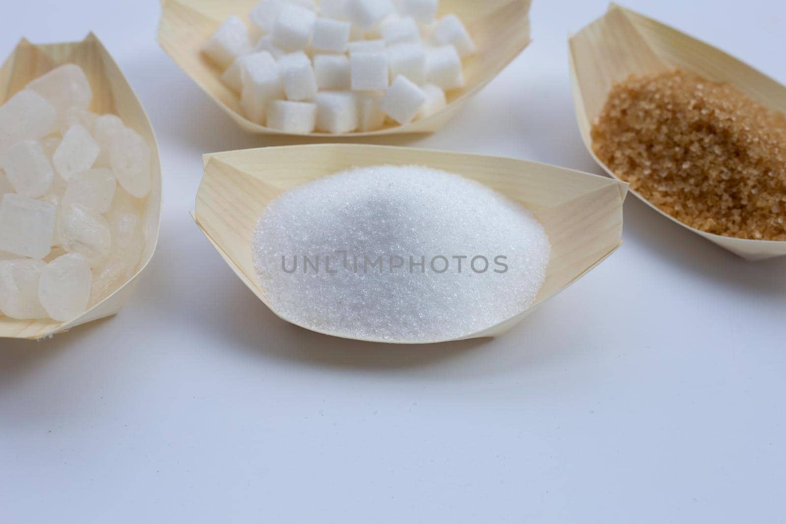 Various types of sugar on white background.