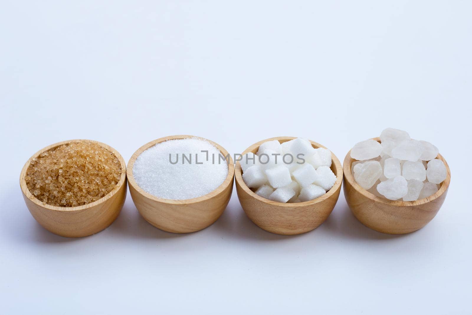 Various types of sugar on white background.