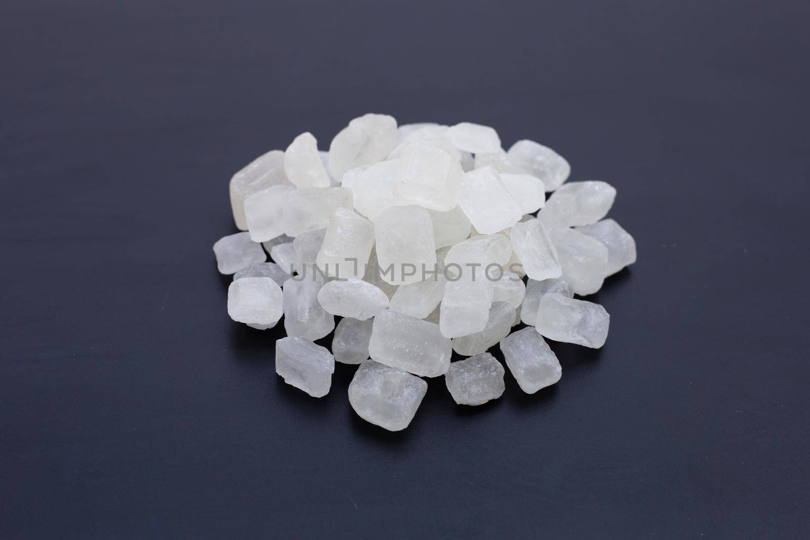 Crystal rock sugar on dark background. 