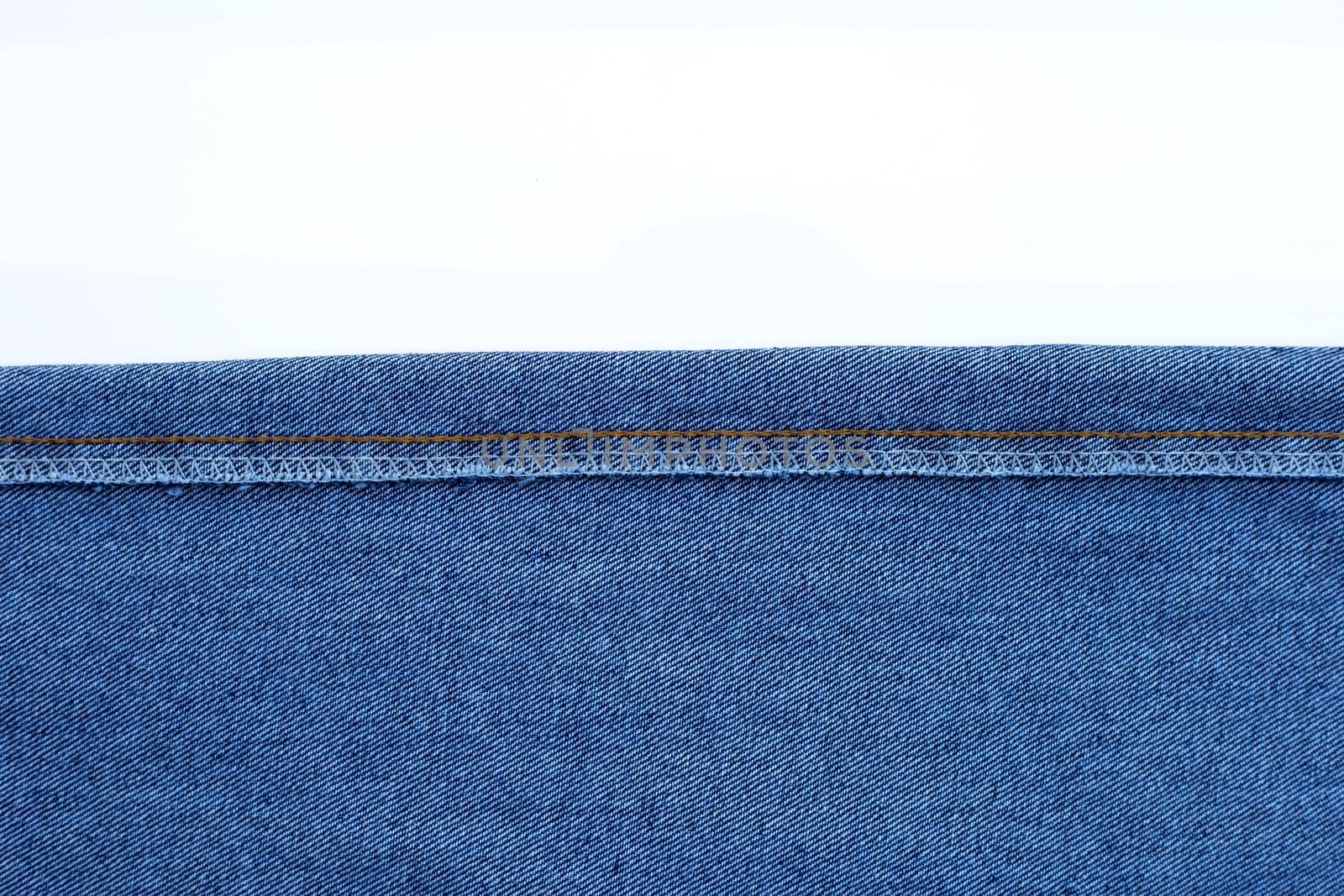 Texture of blue jeans on white background.