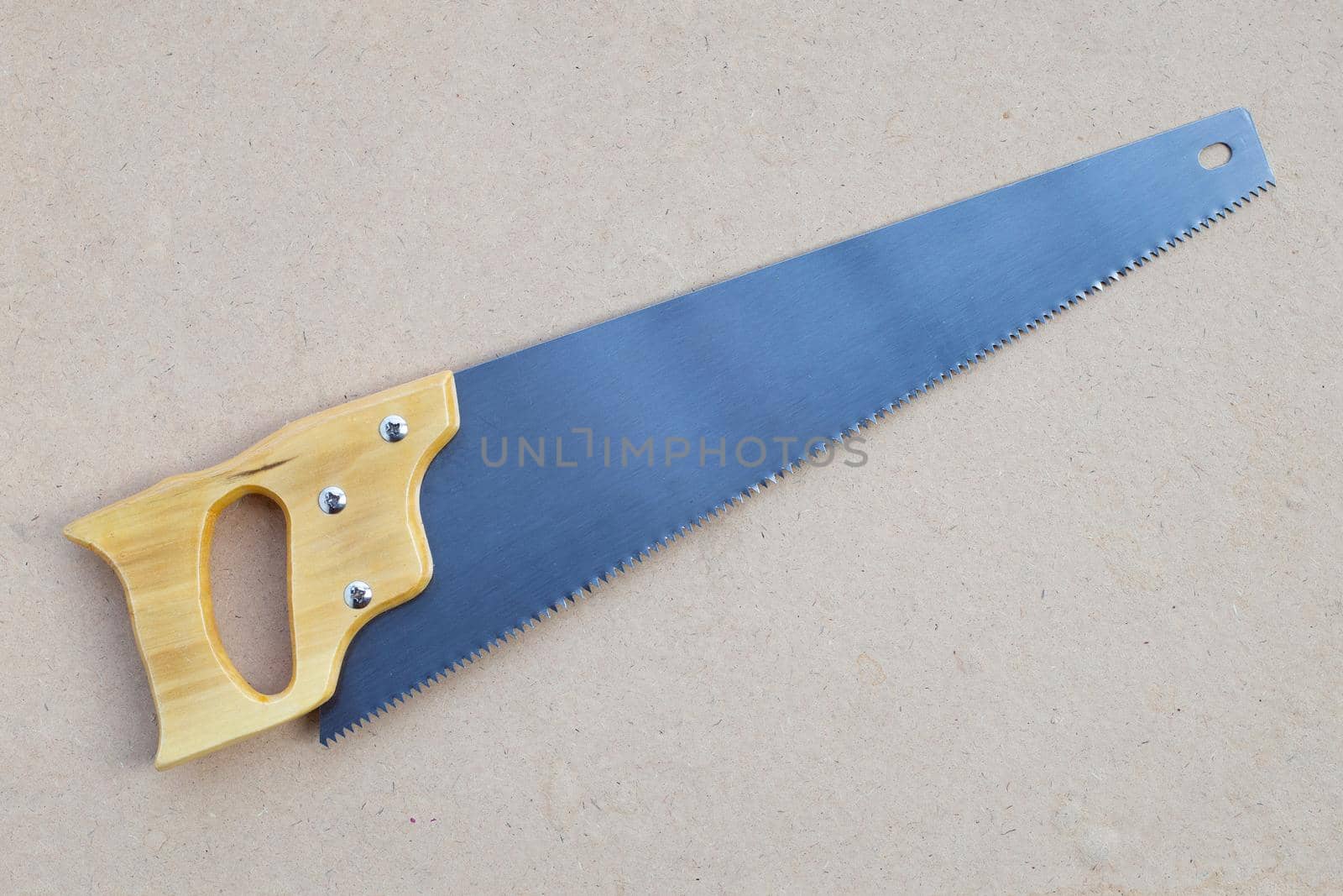 Hand saw on brown background. Top view