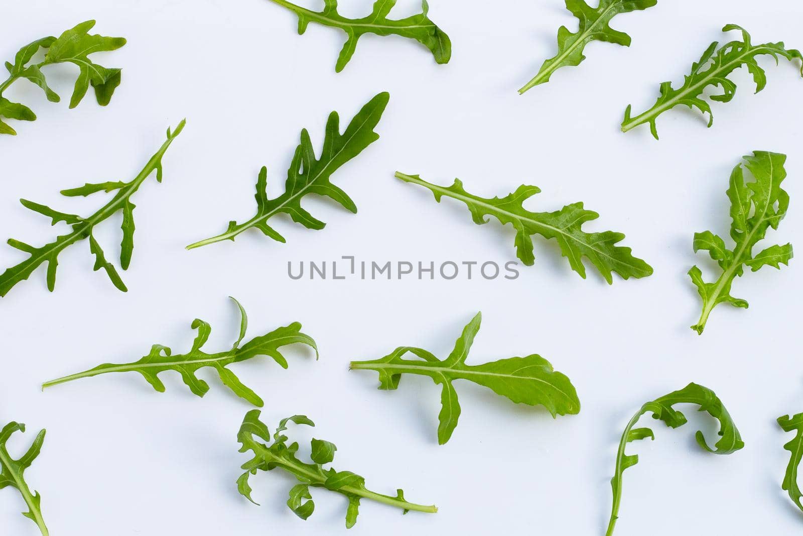 Fresh green rocket salad on white background.