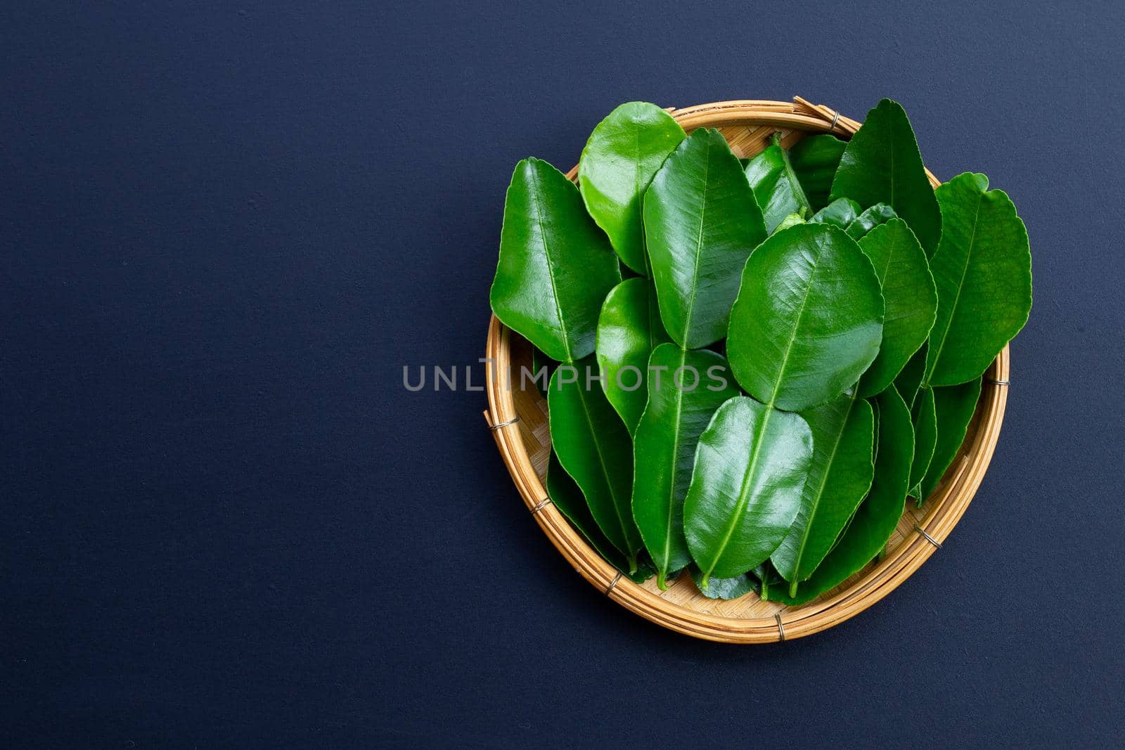 Bergamot kaffir lime leaves herb fresh ingredient on dark background.