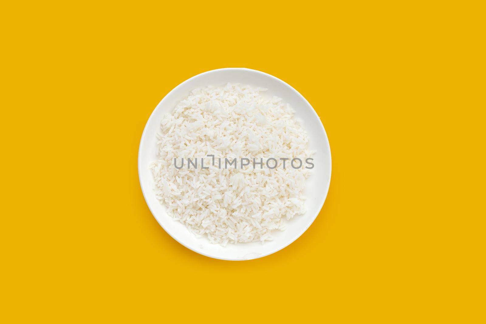 Dish of rice on yellow background. Top view