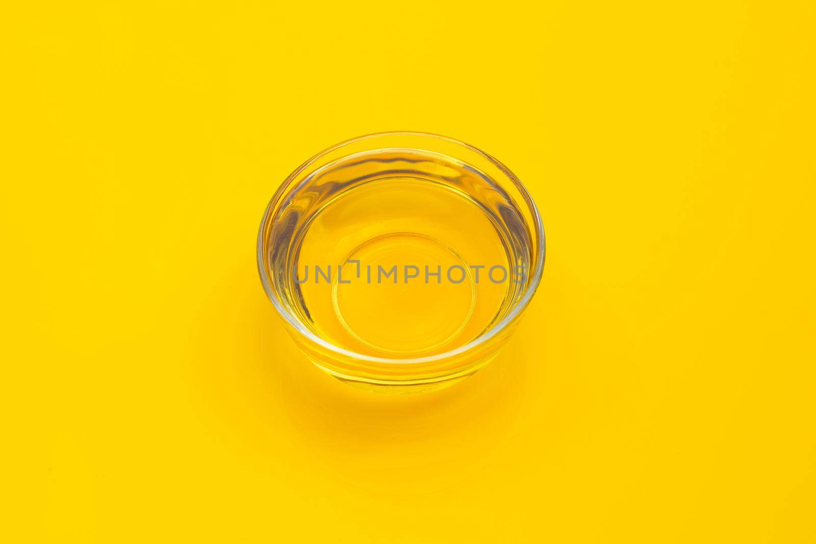 Rice bran oil on yellow background.