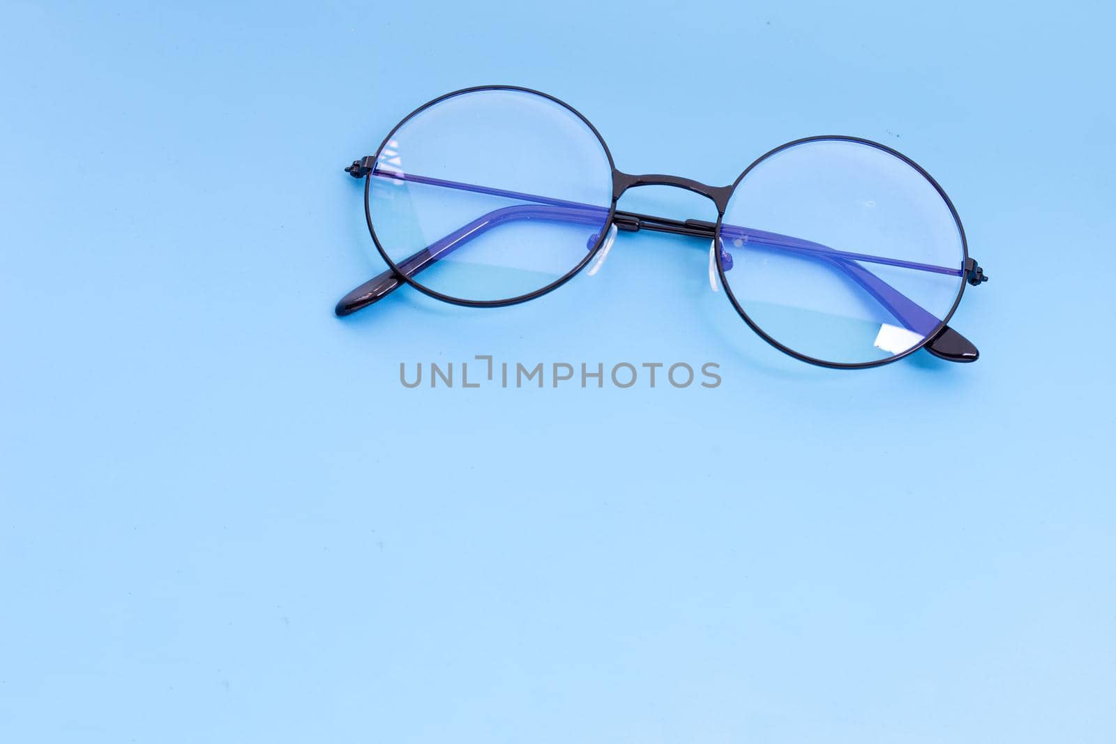 Eye Glasses on blue background. Copy space