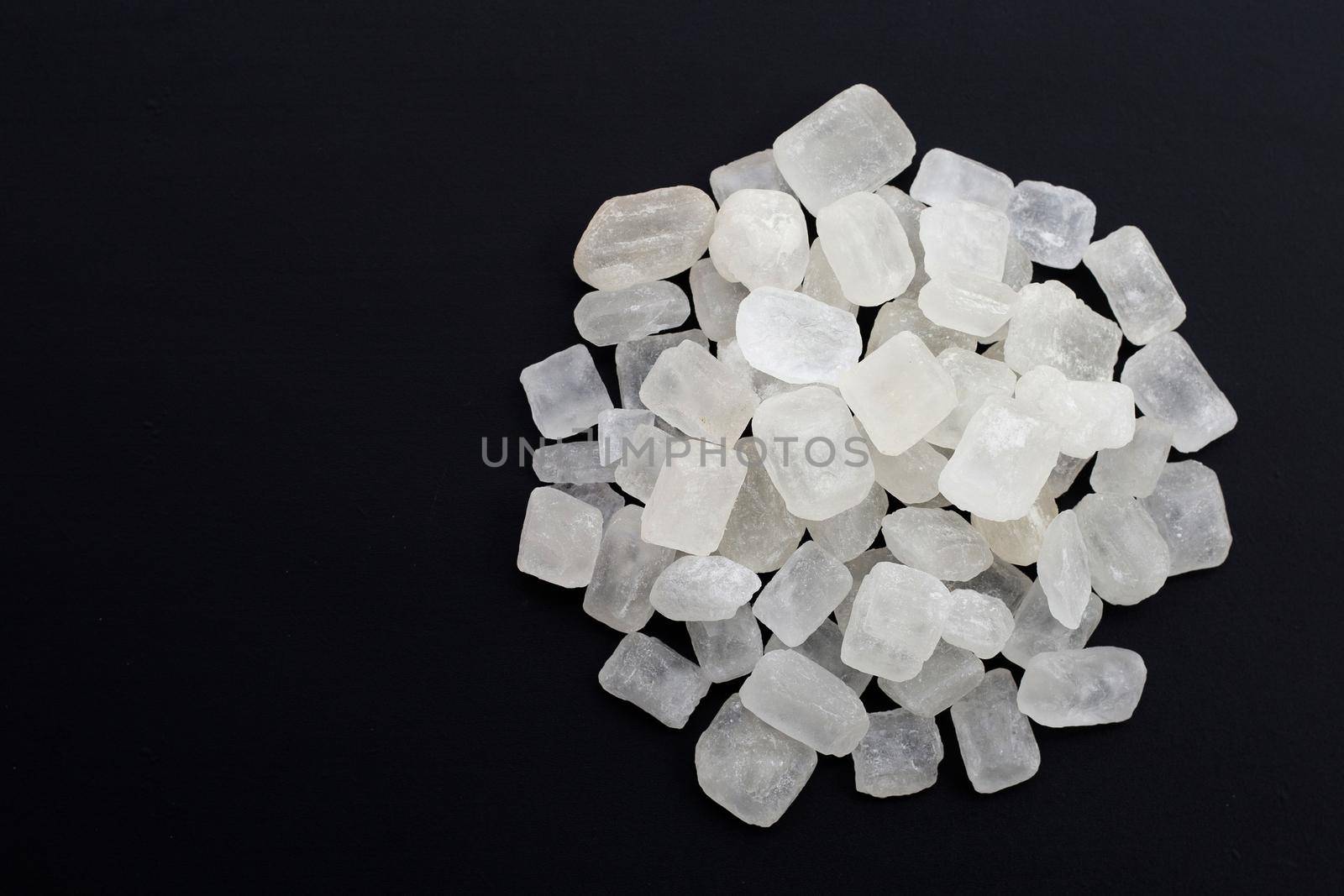 Crystal rock sugar on dark background. 