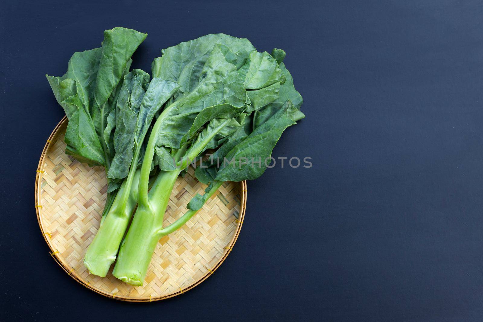 Chinese kale or Kailaan or Hong Kong kale on dark background.