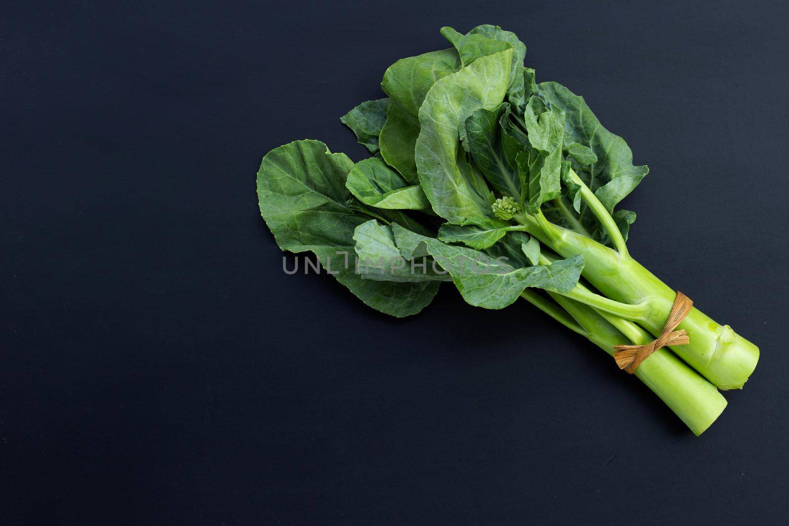 Chinese kale or Kailaan or Hong Kong kale on dark background.