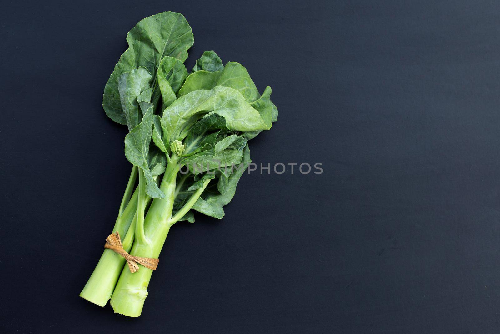 Chinese kale or Kailaan or Hong Kong kale on dark background.