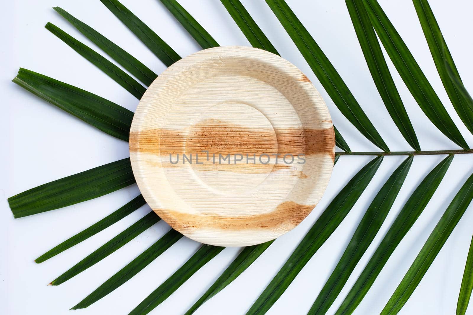 Betel palm leaf plate on white background.