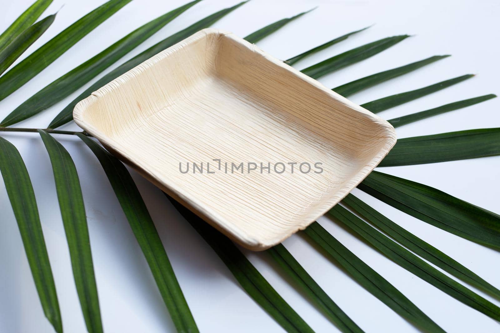 Betel palm leaf plate on white background.