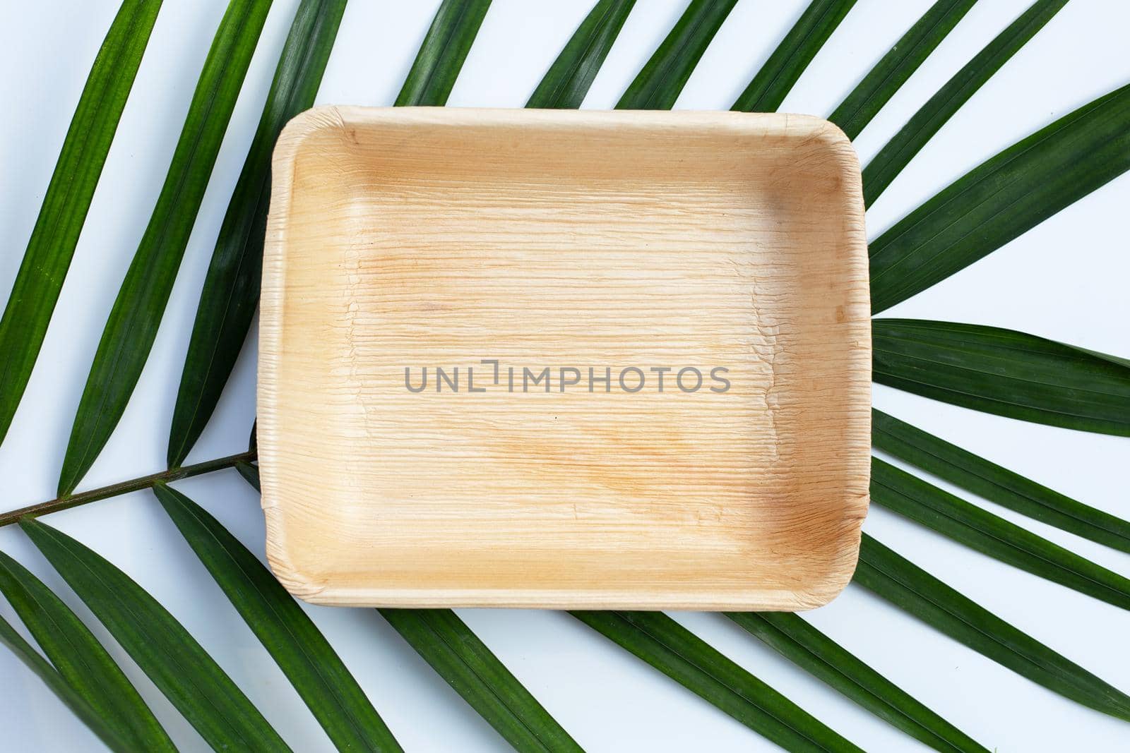 Betel palm leaf plate on white background.