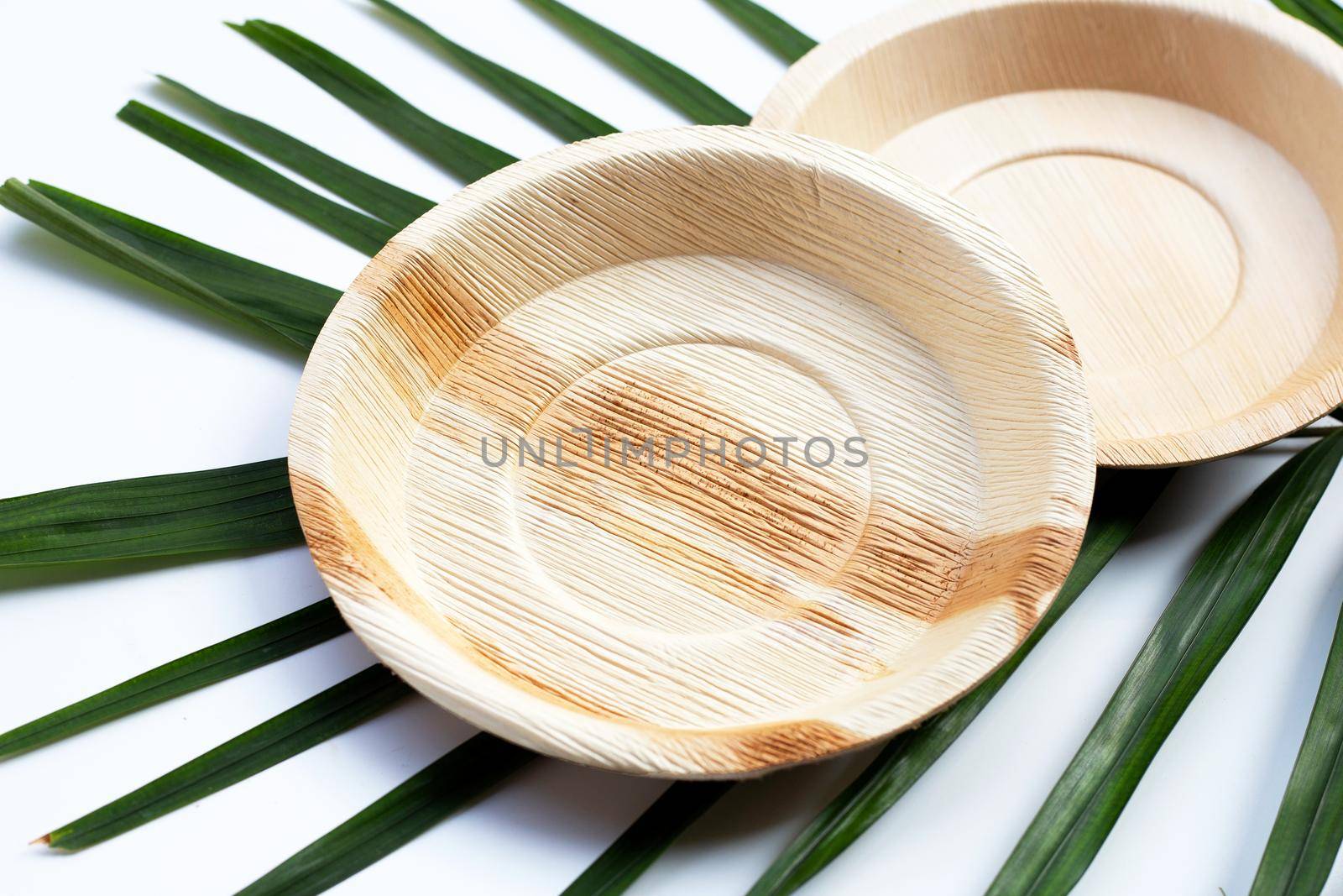 Betel palm leaf plates on white background.
