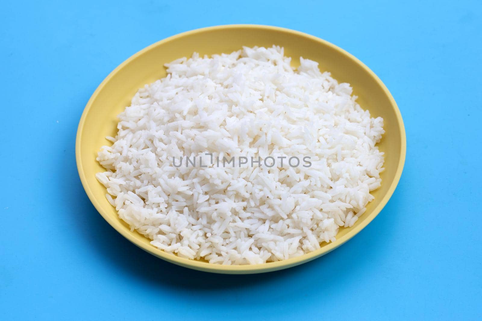 Dish of rice on blue background.