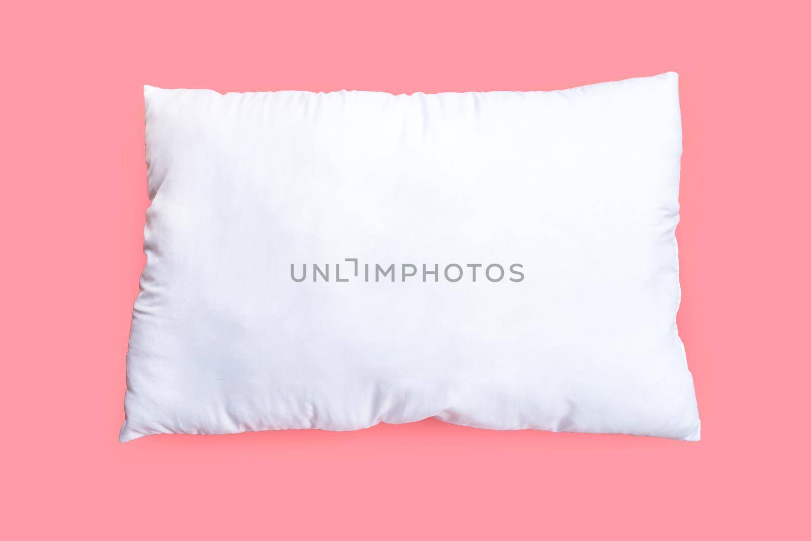 White pillow on pink background.  Top view