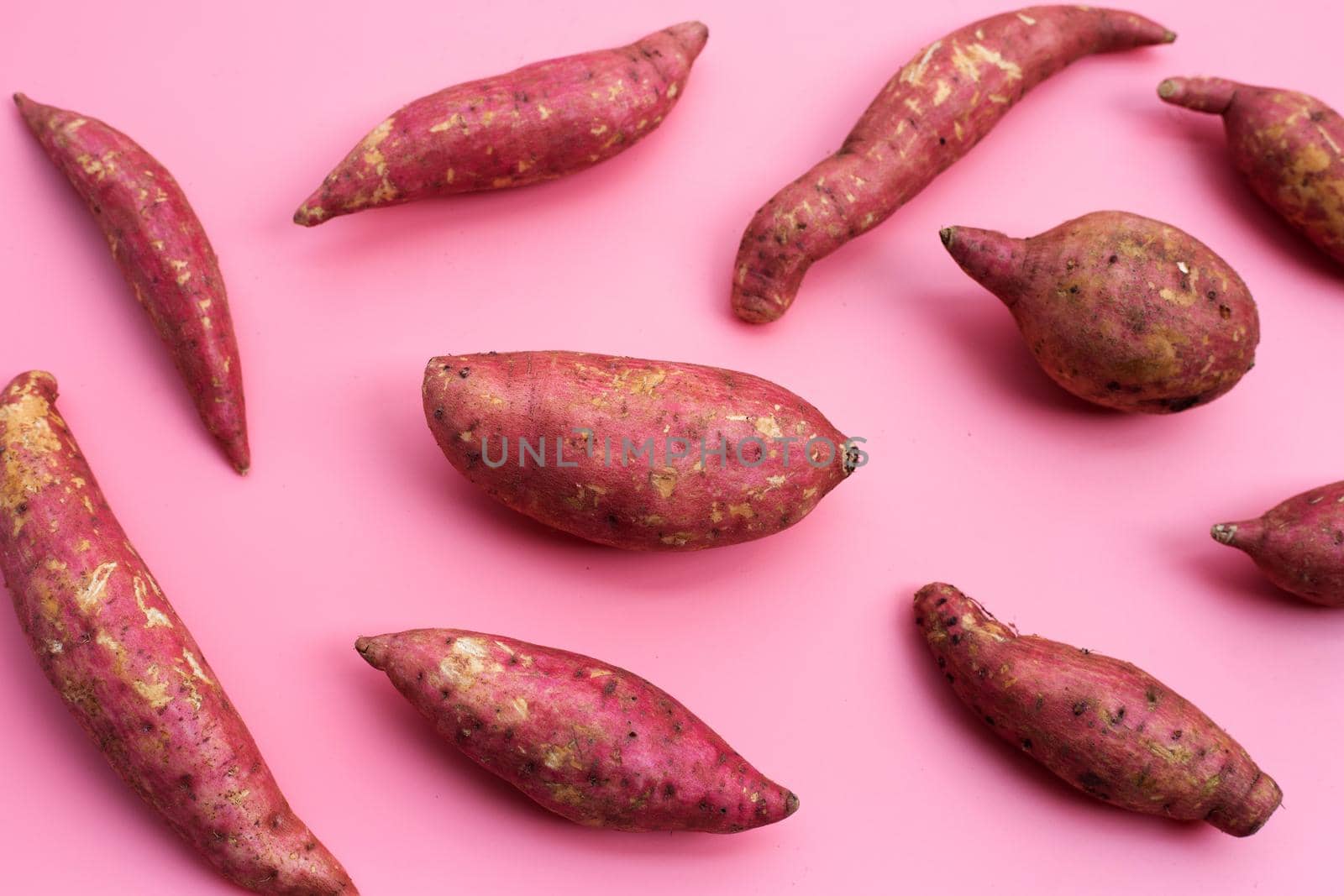 Sweet potato on pink background. Top view
