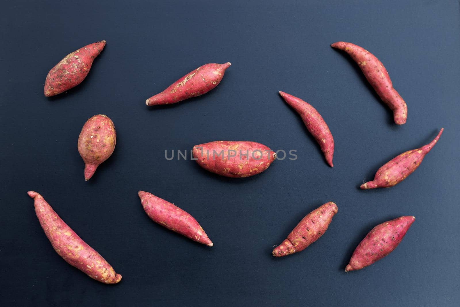Sweet potato on dark background. Top view