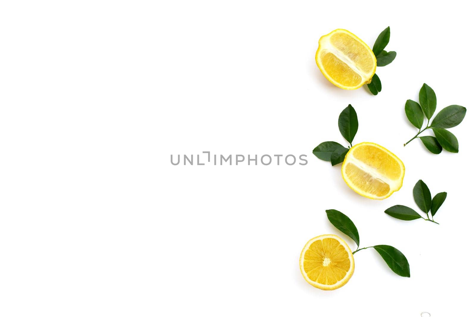 Fresh lemon with green leaves on white background.