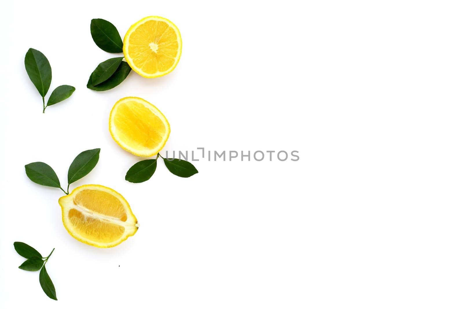Fresh lemon with green leaves on white background.