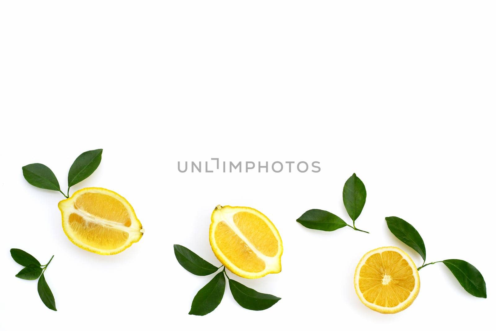 Fresh lemon with green leaves on white background.