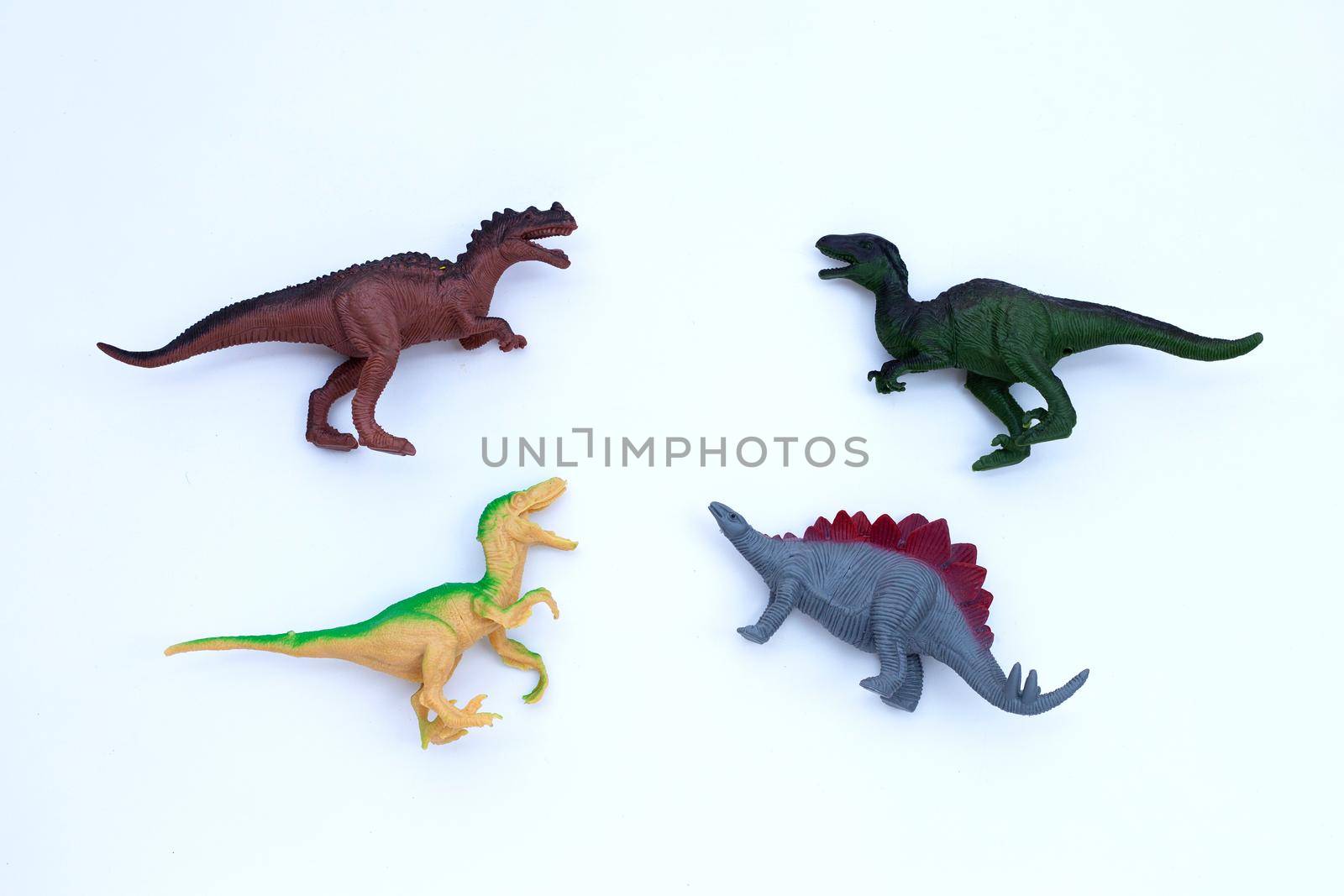 Plastic dinosaur toys on white background. Top view