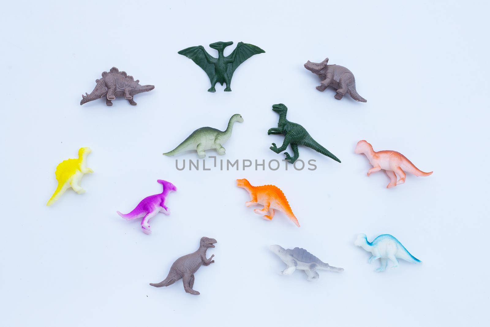 Plastic dinosaur toys on white background. Top view