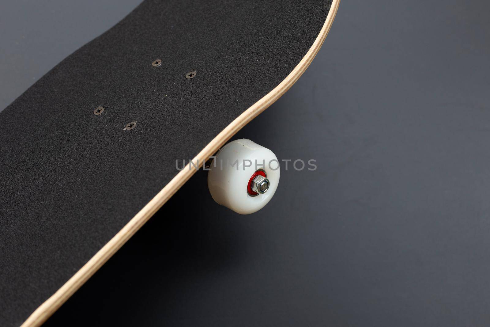 Black skateboard on dark background.