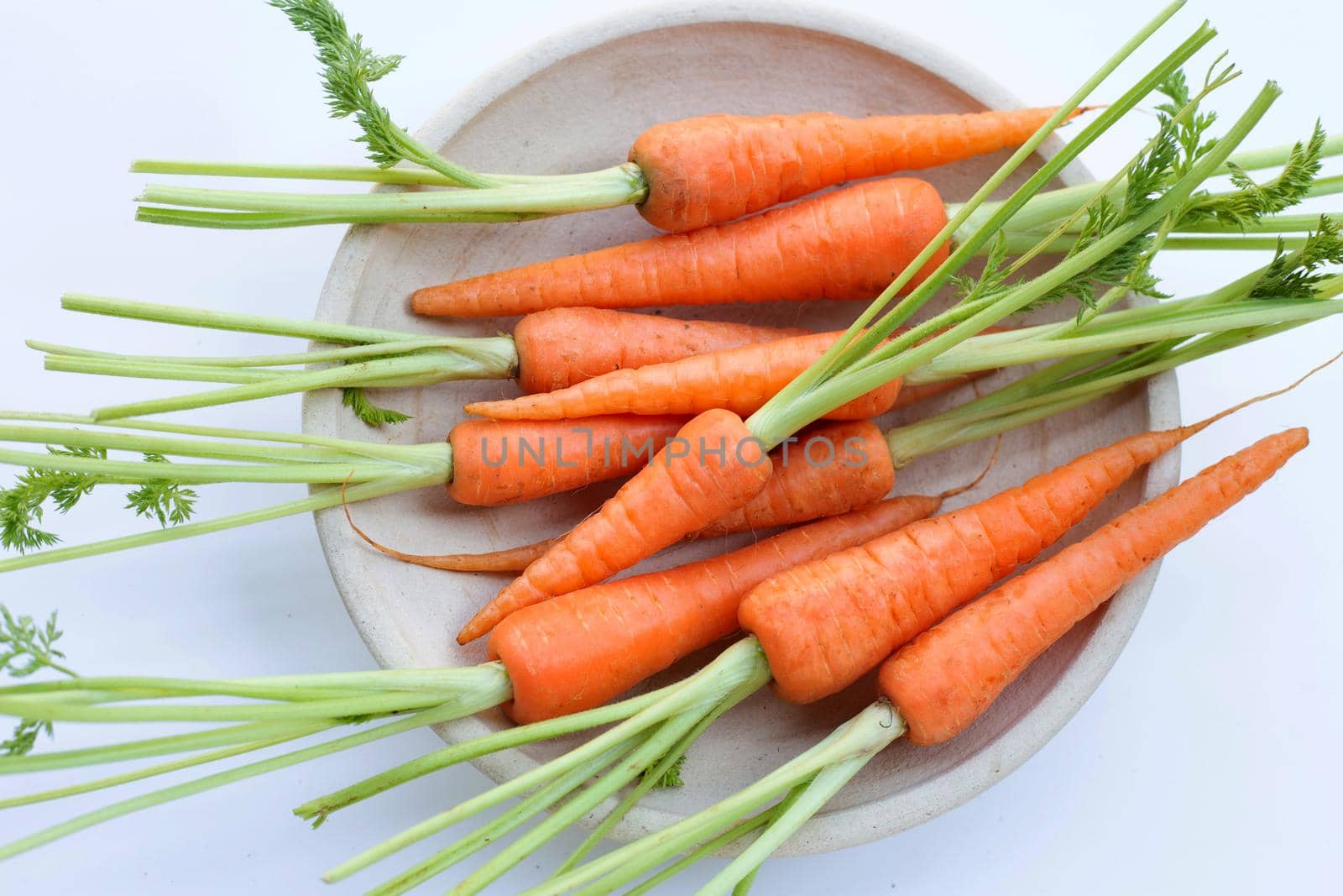 Fresh carrots on white background.