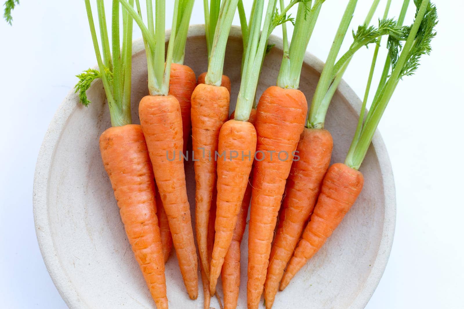 Fresh carrots on white background.