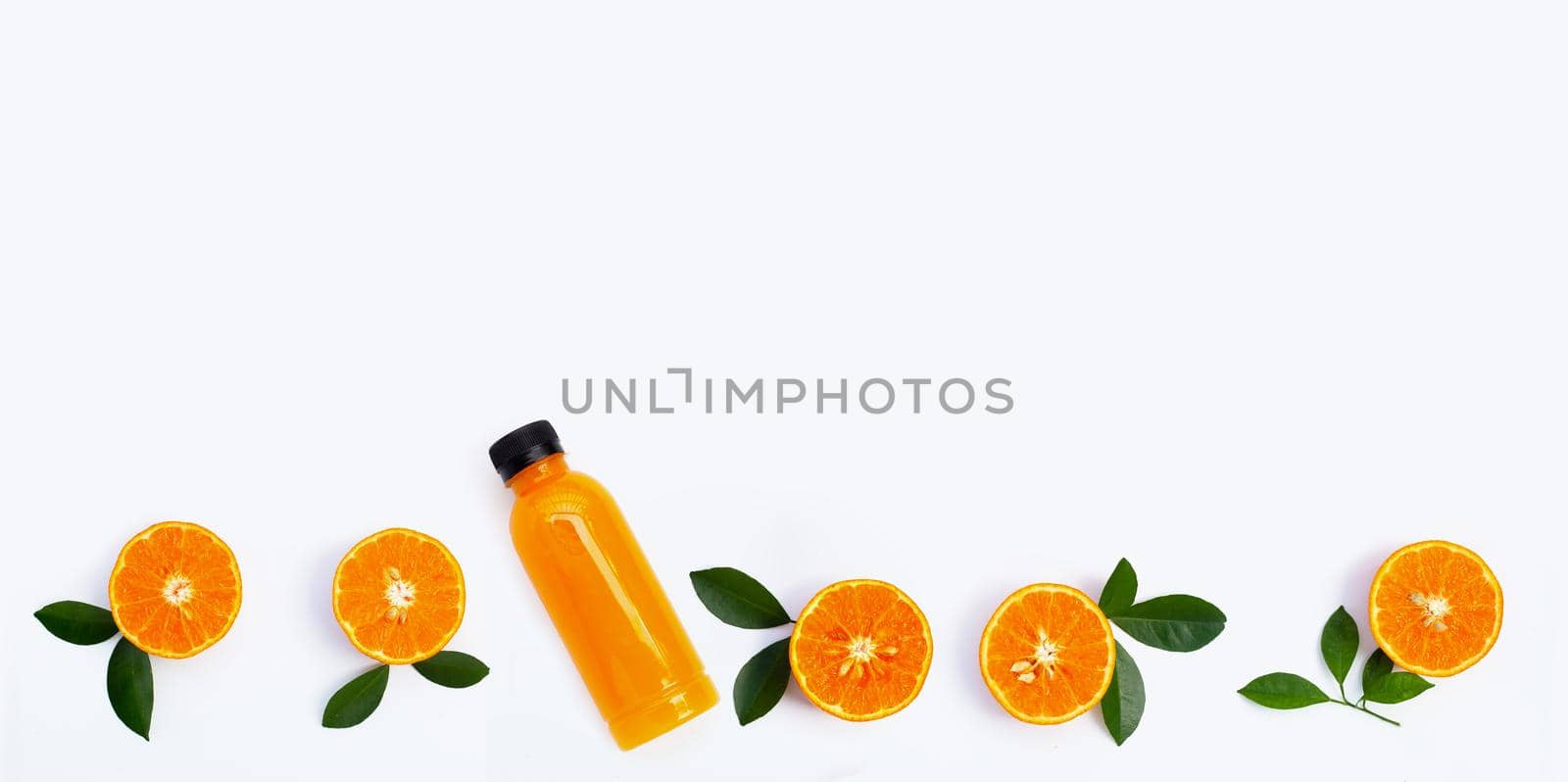 Orange juice in plastic bottle with fresh orange fruit on white background.
