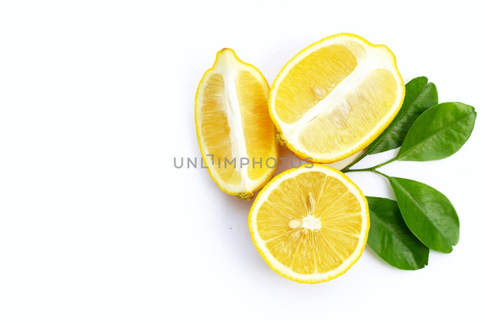 Fresh lemon with green leaves on white background.