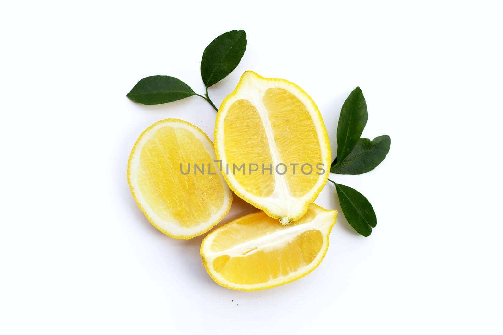 Fresh lemon with green leaves on white background.