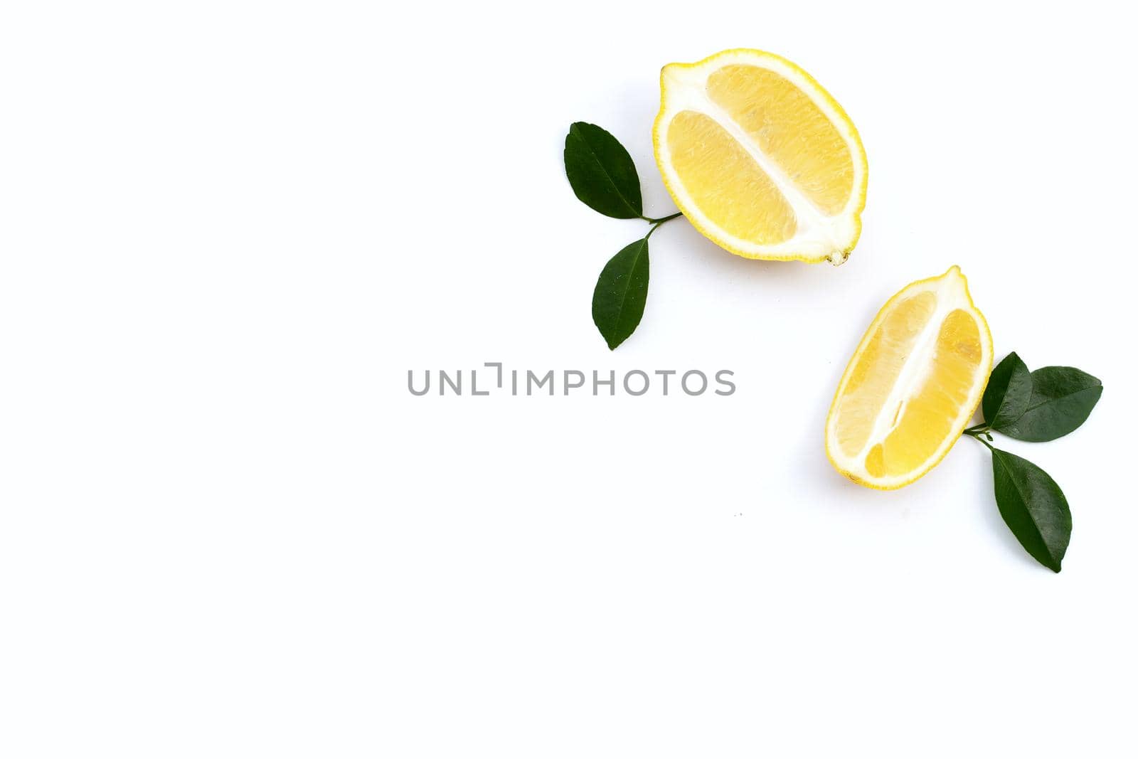 Fresh lemon with green leaves on white background.