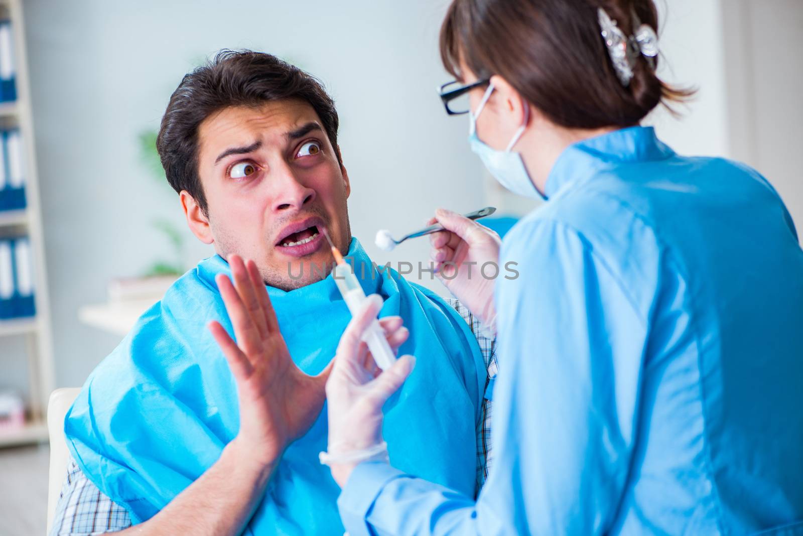 Patient afraid of dentist during doctor visit by Elnur