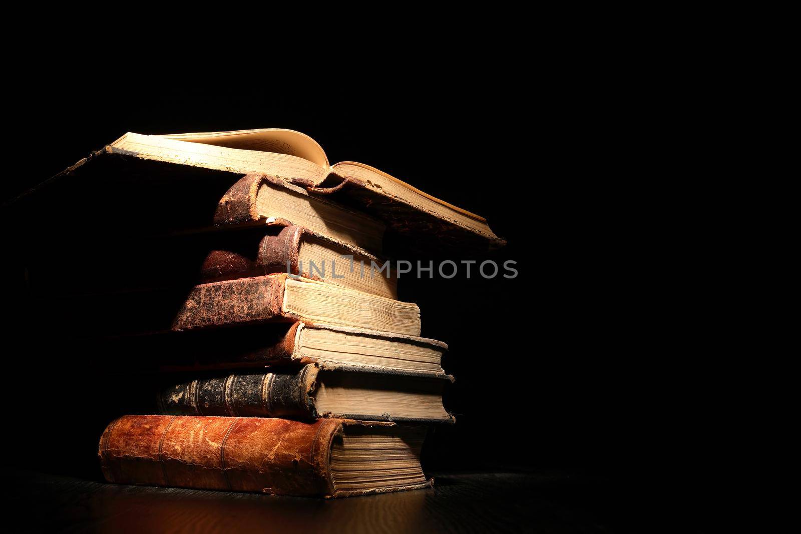 Stack of old books on dark background